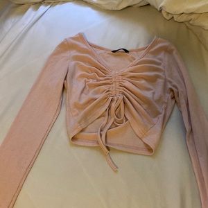 A pink long sleeve crop top